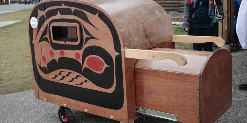 A close-up of the tiny home pod prototype with the sea trout design on the side.