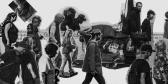 A black and white collage of people walking through Cambpell River.