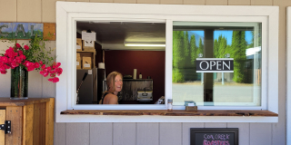 Jan Peavoy sits in the front window of Coal Creek Roasters.